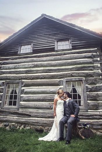 bride and groom by moon log cabin image